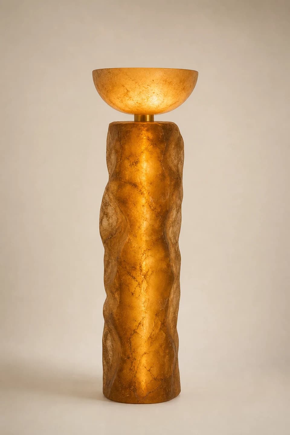 Glowing amber resin floor lamp with a shallow bowl diffuser